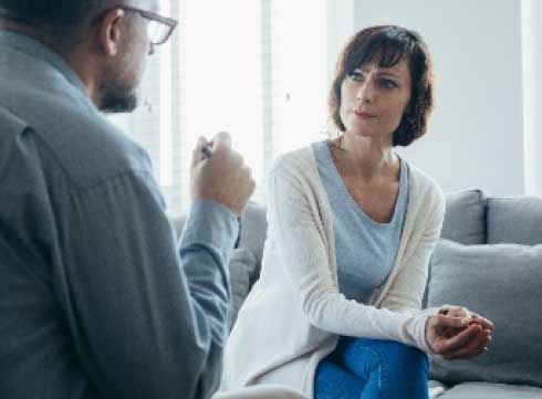 A man talking to a woman in a counselling office