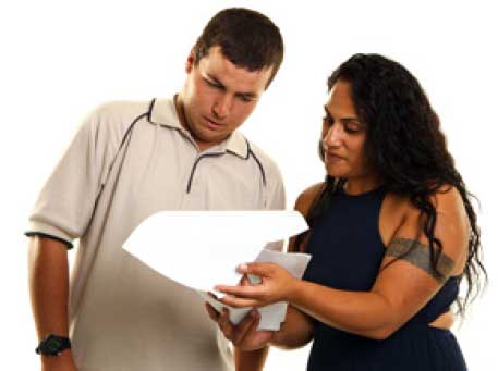 Two people looking at a sheet of paper